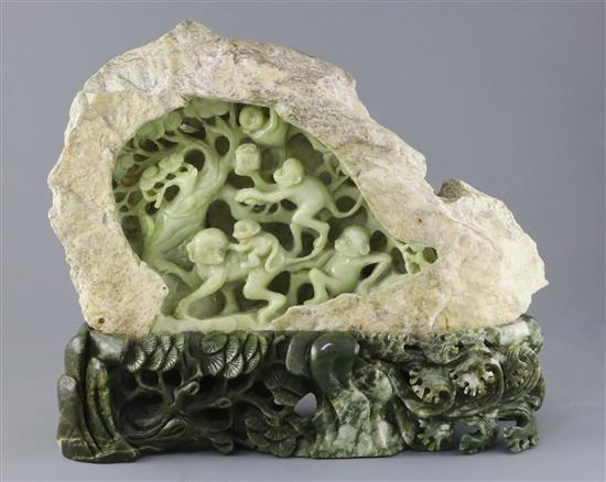 A Chinese bowenite jade boulder carving of monkeys clambering through a pine tree, 20th century, H.35cm W.41cm